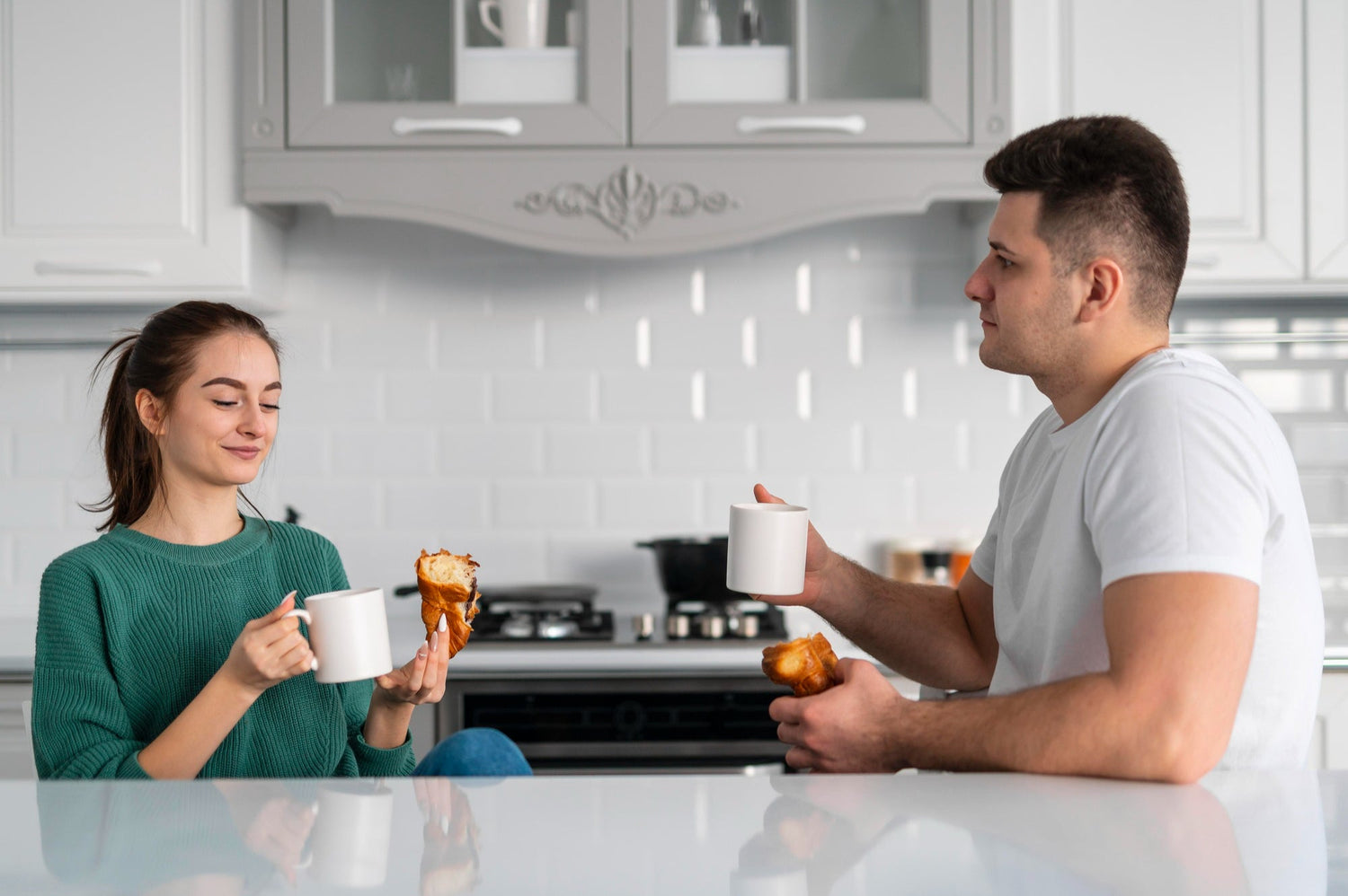 couple sitting at a kitchen table holding hands and speaking calmly