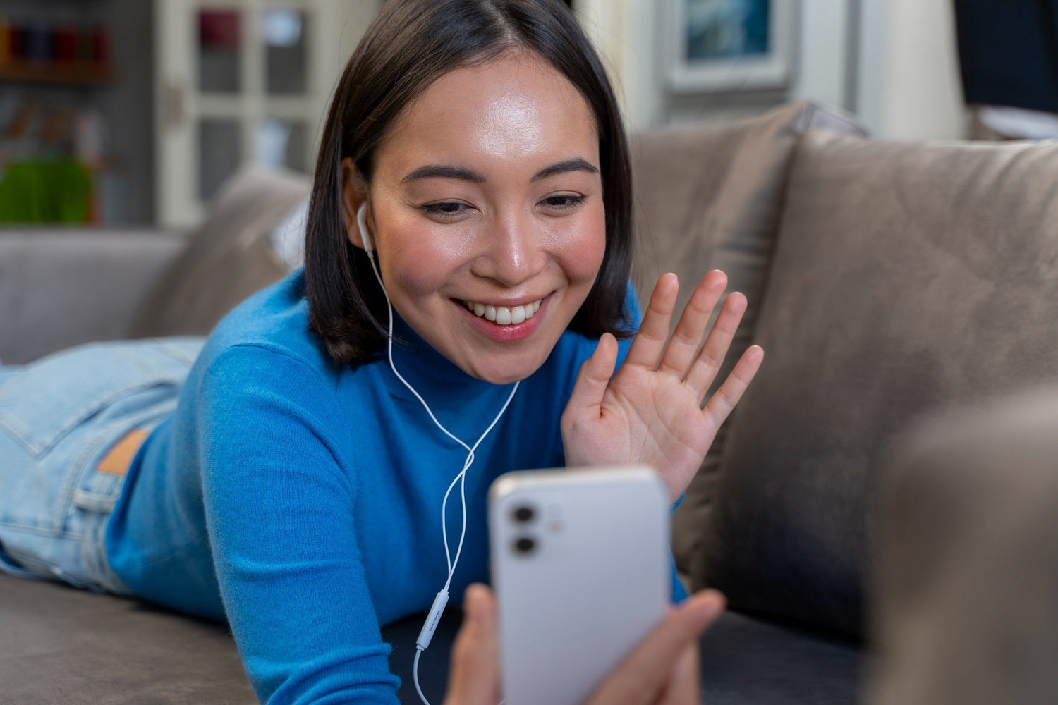 two people smiling on a FaceTime call, soft light, relaxed setting