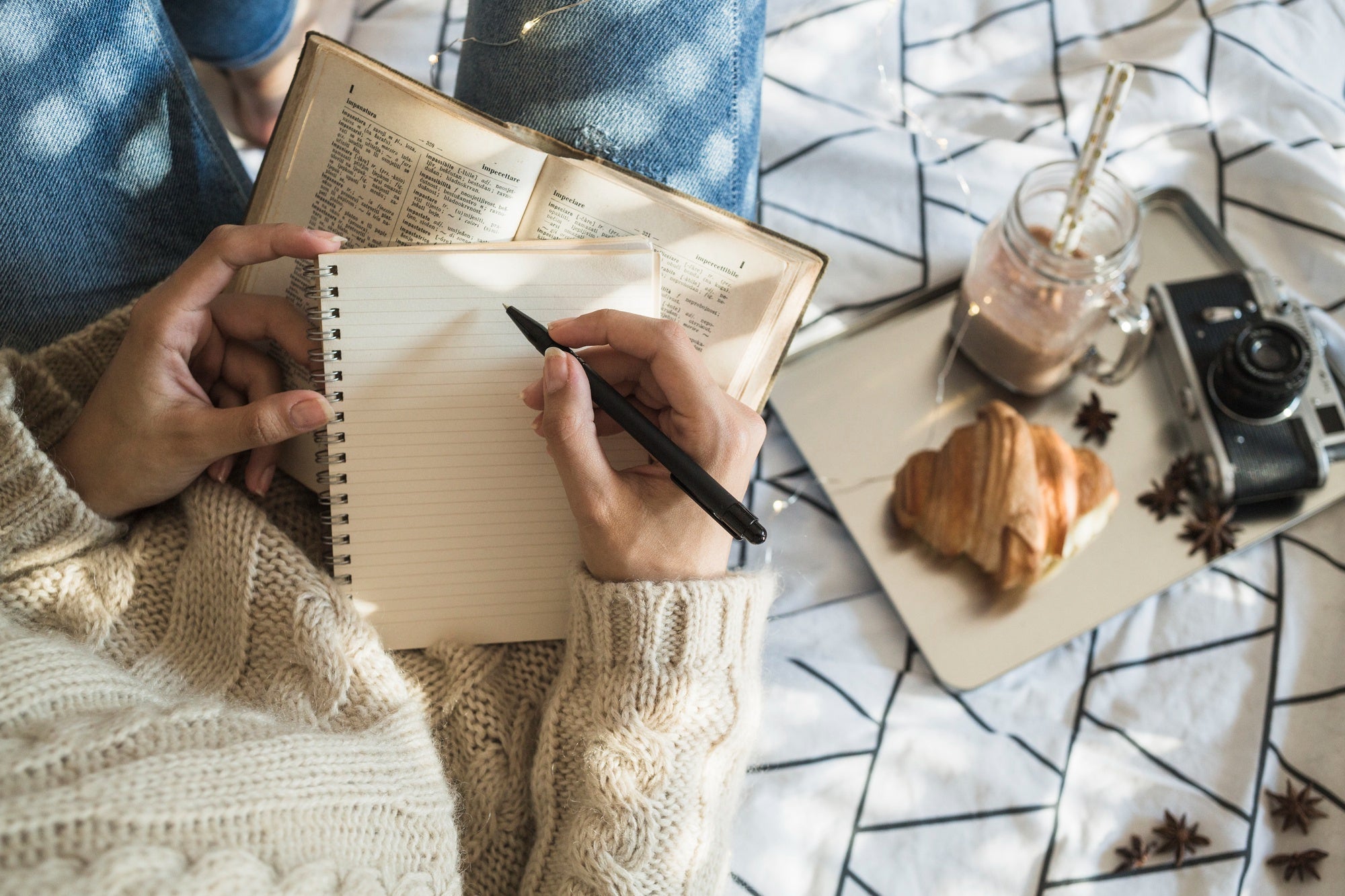 close up of hands resting on a journal with soft light, a calm moment before reflection