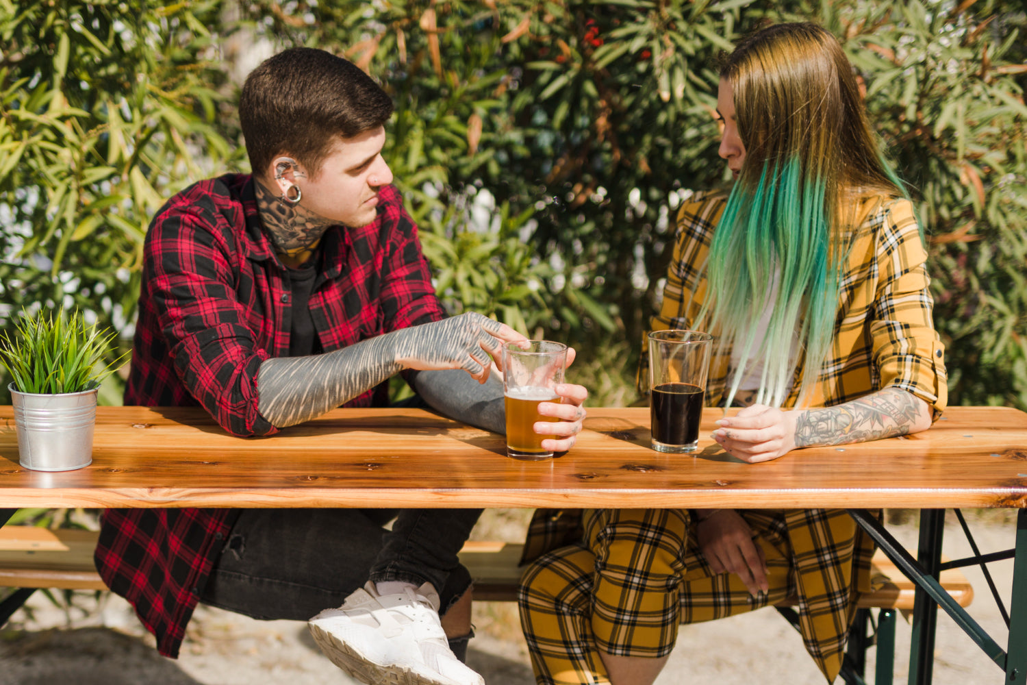 two people chatting over coffee at a sunny community center table